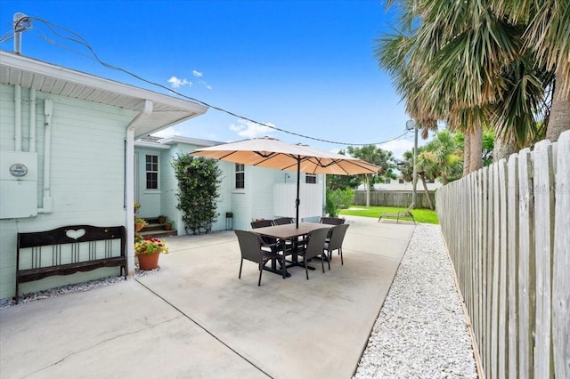 1026 Bel Aire Dr, Daytona Beach, FL 32118 - fenced backyard with a patio and outdoor dining area