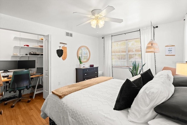 1026 Bel Aire Dr, Daytona Beach, FL 32118 - bedroom with wood finished floors, a desk, a ceiling fan, and a closet