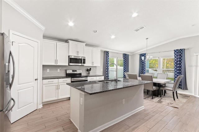 392 S Hamilton Springs Rd, Saint Augustine, FL 32084 - kitchen featuring stainless steel appliances, lofted ceiling, light wood-type flooring, crown molding, and white cabinetry
