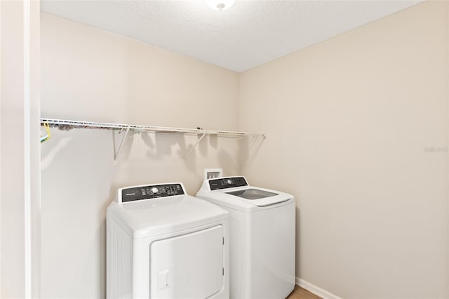 392 S Hamilton Springs Rd, Saint Augustine, FL 32084 - laundry room featuring separate washer and dryer and a textured ceiling
