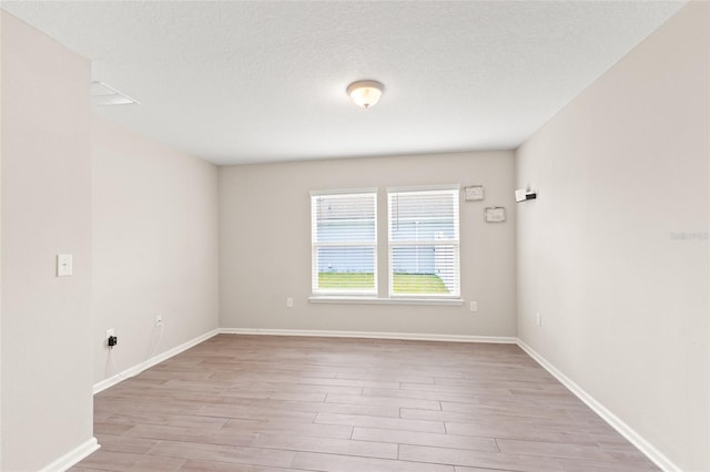 392 S Hamilton Springs Rd, Saint Augustine, FL 32084 - empty room featuring light wood-type flooring and a textured ceiling