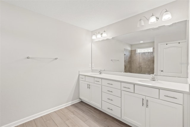 392 S Hamilton Springs Rd, Saint Augustine, FL 32084 - bathroom with double vanity, a tile shower, and wood finished floors