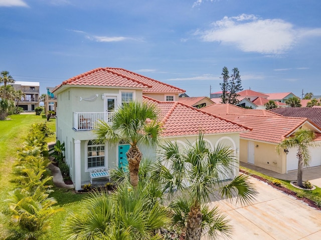 1528 N Daytona Ave, Flagler Beach, FL 32136 - mediterranean / spanish-style home with stucco siding, a tiled roof, concrete driveway, and a garage