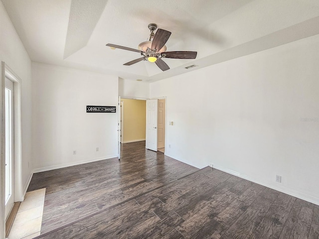 1528 N Daytona Ave, Flagler Beach, FL 32136 - empty room featuring wood finished floors, ceiling fan, and a tray ceiling