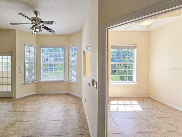 1528 N Daytona Ave, Flagler Beach, FL 32136 - tiled spare room with a ceiling fan and a textured ceiling