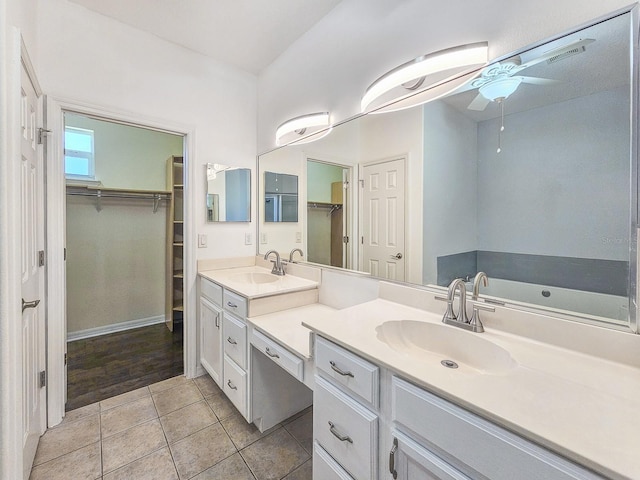 1528 N Daytona Ave, Flagler Beach, FL 32136 - bathroom with ceiling fan, double vanity, a spacious closet, and tile patterned floors
