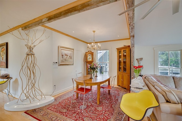 603 Front St, Welaka, FL 32193 - dining area featuring a chandelier, wood finished floors, beam ceiling, and ornamental molding
