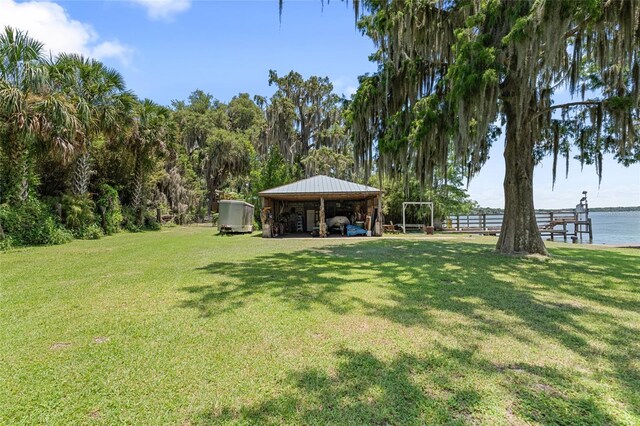 603 Front St, Welaka, FL 32193 - view of grassy yard with a detached carport and a water view