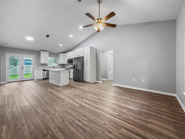 204 S Forsyth St, Bunnell, FL 32110 - kitchen with appliances with stainless steel finishes, open floor plan, a ceiling fan, dark wood finished floors, and high vaulted ceiling