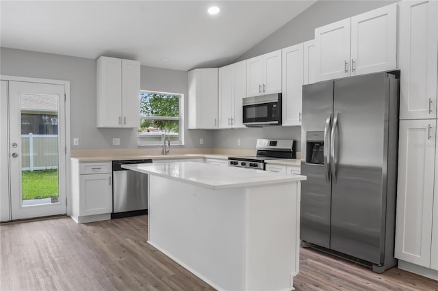 204 S Forsyth St, Bunnell, FL 32110 - kitchen with appliances with stainless steel finishes, light wood-style floors, light countertops, white cabinets, and lofted ceiling