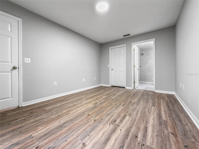 204 S Forsyth St, Bunnell, FL 32110 - unfurnished bedroom featuring wood finished floors and ensuite bathroom