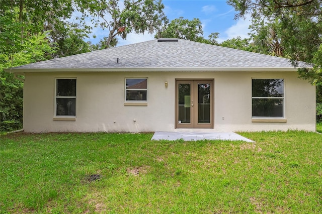 204 S Forsyth St, Bunnell, FL 32110 - rear view of house featuring a shingled roof, stucco siding, a lawn, and french doors