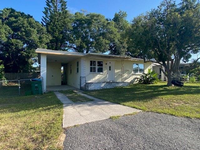 264 Sherwood Ln, Daytona Beach, FL 32117 - view of front facade with driveway and a carport