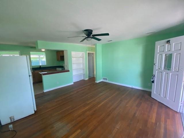 264 Sherwood Ln, Daytona Beach, FL 32117 - unfurnished living room featuring a ceiling fan and dark wood-style flooring