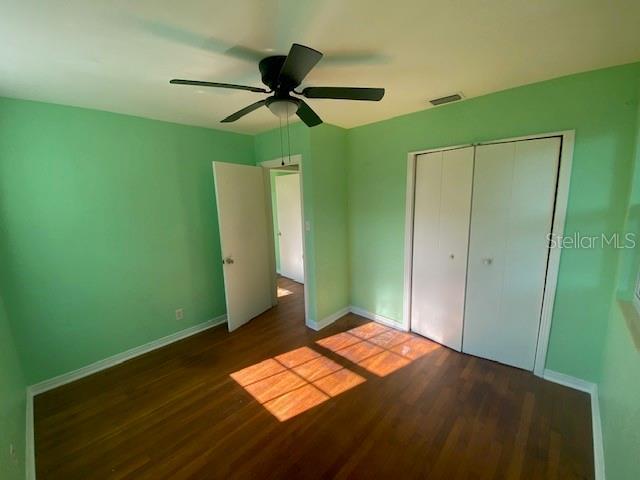 264 Sherwood Ln, Daytona Beach, FL 32117 - unfurnished bedroom with wood finished floors, a closet, and a ceiling fan