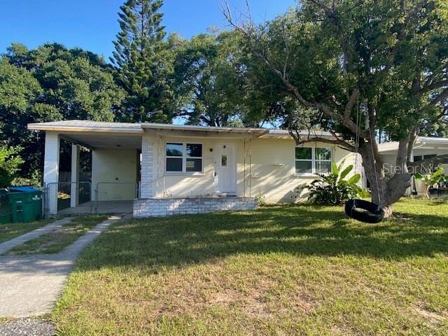 264 Sherwood Ln, Daytona Beach, FL 32117 - manufactured / mobile home with a front yard, an attached carport, and driveway