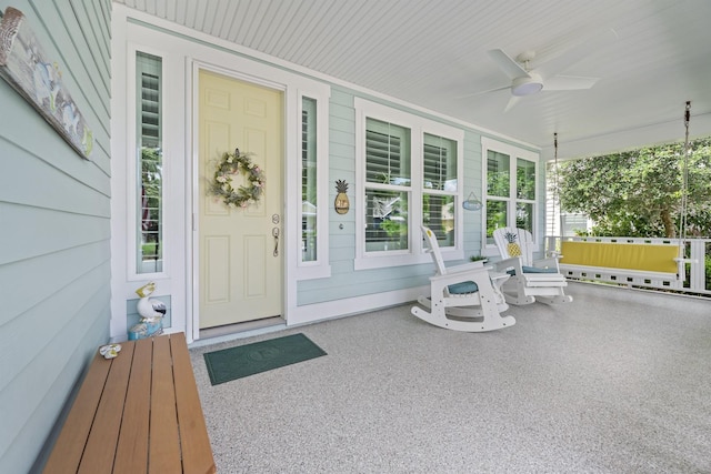 31 Hidden Treasure Dr, Palm Coast, FL 32137 - doorway to property featuring covered porch and a ceiling fan