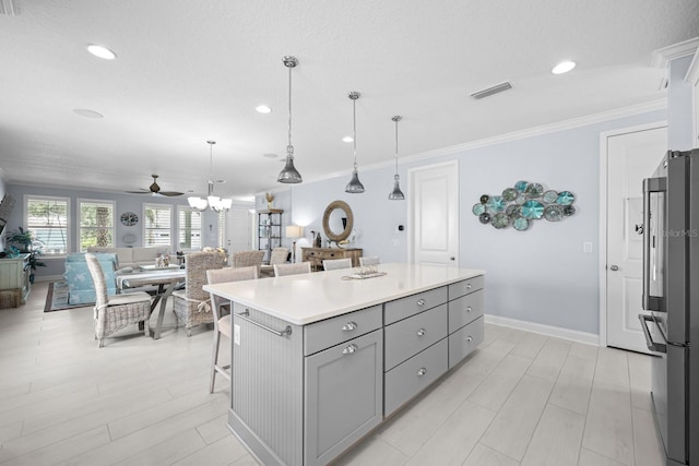 31 Hidden Treasure Dr, Palm Coast, FL 32137 - kitchen with gray cabinets, crown molding, a ceiling fan, high quality fridge, and open floor plan
