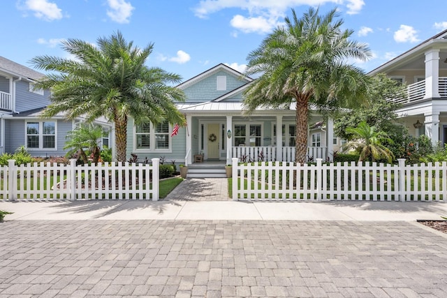 31 Hidden Treasure Dr, Palm Coast, FL 32137 - view of front of house with a porch, a fenced front yard, and a standing seam roof