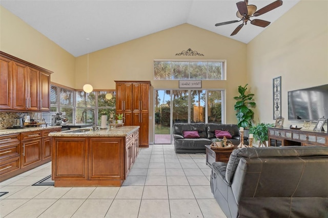 15522 NW 12th Ct, Pembroke Pines, FL 33028 - kitchen with high vaulted ceiling, open floor plan, light tile patterned floors, ceiling fan, and light stone countertops