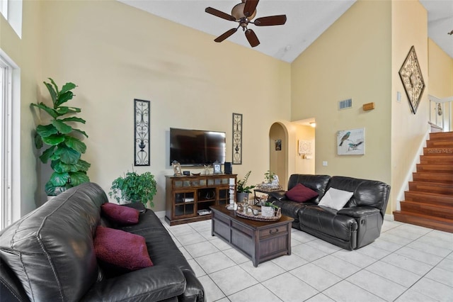 15522 NW 12th Ct, Pembroke Pines, FL 33028 - living area featuring a ceiling fan, high vaulted ceiling, light tile patterned floors, arched walkways, and stairway