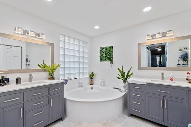 15522 NW 12th Ct, Pembroke Pines, FL 33028 - bathroom featuring two vanities, a garden tub, and recessed lighting