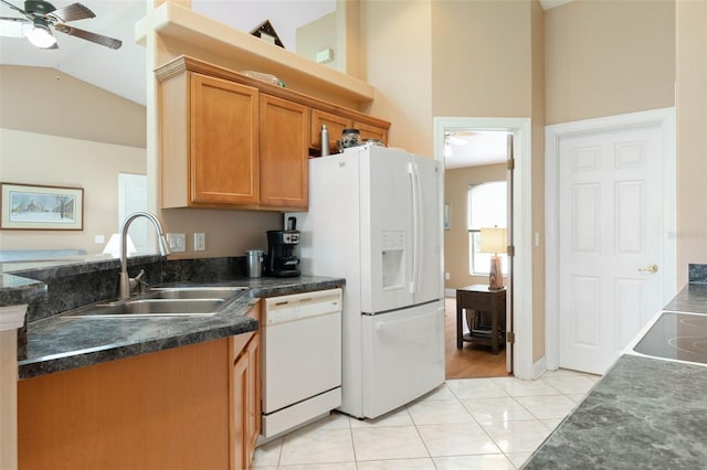 6 Prince Michael Ln, Palm Coast, FL 32164 - kitchen with white appliances, a ceiling fan, vaulted ceiling, dark countertops, and brown cabinets
