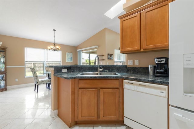 6 Prince Michael Ln, Palm Coast, FL 32164 - kitchen featuring white appliances, brown cabinetry, a chandelier, a peninsula, and vaulted ceiling
