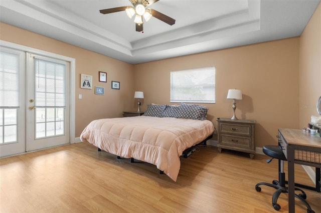 6 Prince Michael Ln, Palm Coast, FL 32164 - bedroom featuring a raised ceiling, light wood-type flooring, access to exterior, french doors, and ceiling fan