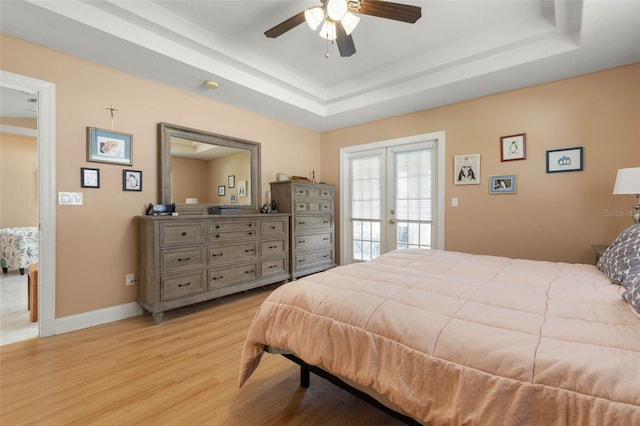 6 Prince Michael Ln, Palm Coast, FL 32164 - bedroom with a tray ceiling, light wood finished floors, a ceiling fan, and french doors