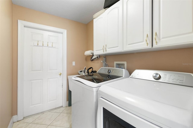 6 Prince Michael Ln, Palm Coast, FL 32164 - laundry area featuring washing machine and dryer, cabinet space, and light tile patterned floors