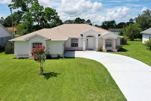 6 Prince Michael Ln, Palm Coast, FL 32164 - view of front of house featuring curved driveway, stucco siding, a front lawn, and a shingled roof