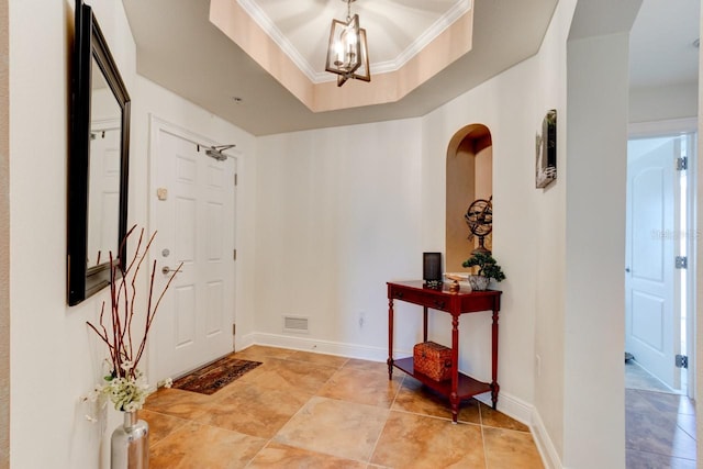 146 Palm Coast Resort Blvd Unit 501, Palm Coast, FL 32137 - entrance foyer with ornamental molding, a chandelier, and a tray ceiling