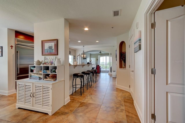 146 Palm Coast Resort Blvd Unit 501, Palm Coast, FL 32137 - hallway featuring arched walkways, a chandelier, recessed lighting, and light tile patterned floors