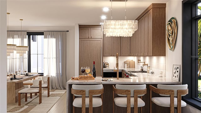 2360 Ocean Shore Blvd Unit 18, Ormond Beach, FL 32176 - bar area featuring a chandelier, hanging light fixtures, and tasteful backsplash