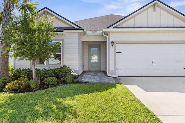 43 Lumber Jack Trl, Palm Coast, FL 32137 - view of front of house with board and batten siding, roof with shingles, a front lawn, driveway, and an attached garage