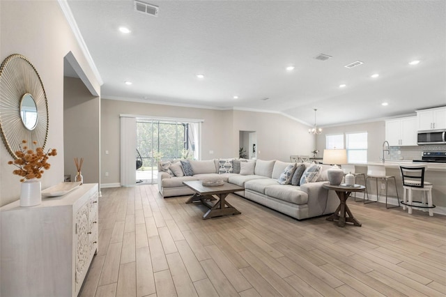 43 Lumber Jack Trl, Palm Coast, FL 32137 - living room featuring ornamental molding, light wood finished floors, recessed lighting, and a chandelier