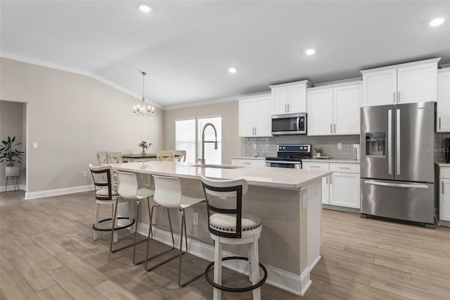 43 Lumber Jack Trl, Palm Coast, FL 32137 - kitchen featuring stainless steel appliances, lofted ceiling, ornamental molding, backsplash, and light countertops