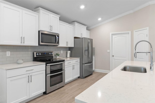 43 Lumber Jack Trl, Palm Coast, FL 32137 - kitchen with stainless steel appliances, light wood-style flooring, tasteful backsplash, ornamental molding, and white cabinets