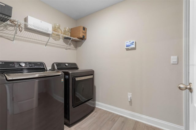 43 Lumber Jack Trl, Palm Coast, FL 32137 - laundry area featuring washing machine and clothes dryer and light wood-style flooring