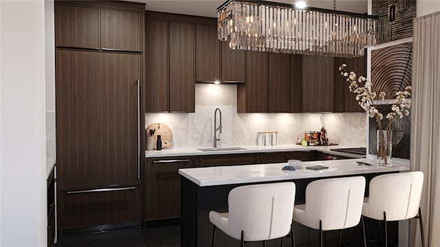 2360 Ocean Shore Blvd Unit 11, Ormond Beach, FL 32176 - kitchen with paneled refrigerator, dark brown cabinets, and a kitchen bar