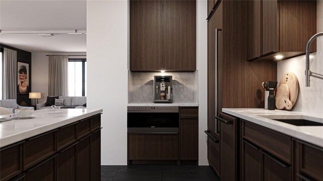 2360 Ocean Shore Blvd Unit 11, Ormond Beach, FL 32176 - kitchen with light countertops, dark brown cabinetry, dark tile patterned flooring, open floor plan, and wall oven