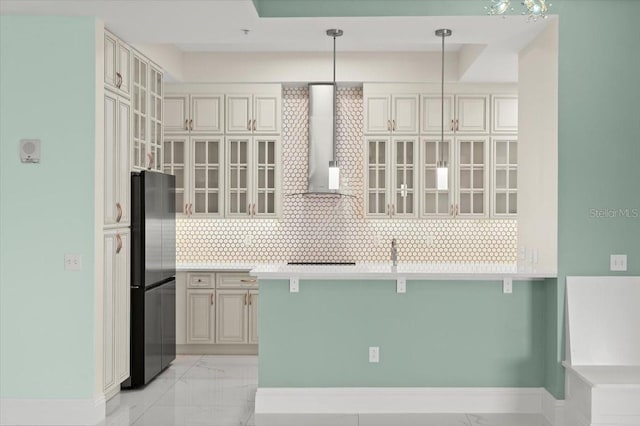 200 Ocean Crest Dr Unit 1111, Palm Coast, FL 32137 - kitchen featuring wall chimney range hood, freestanding refrigerator, decorative backsplash, a kitchen bar, and glass insert cabinets