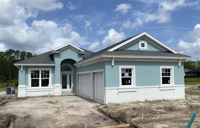 245 Hawthorn Ave, Palm Coast, FL 32164 - view of front of property featuring roof with shingles, an attached garage, concrete driveway, and stucco siding