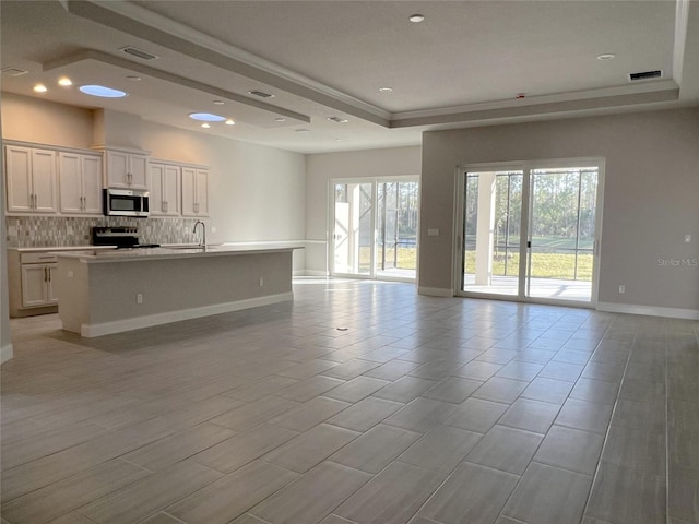 219 Hawthorn Ave, Palm Coast, FL 32164 - unfurnished living room with a raised ceiling and recessed lighting