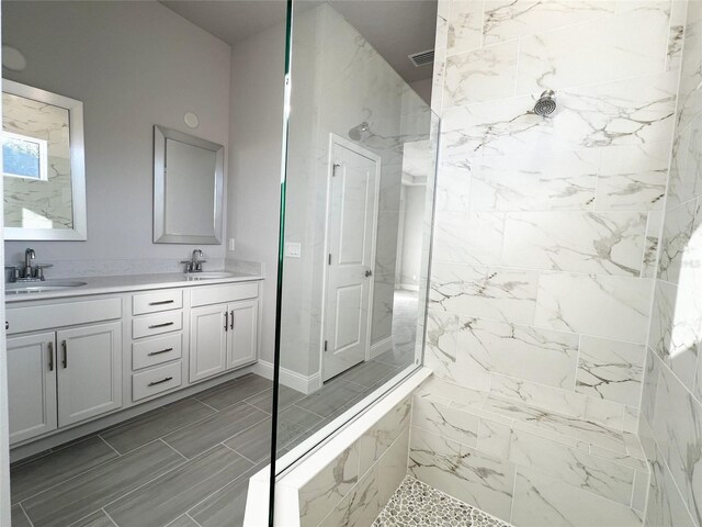 219 Hawthorn Ave, Palm Coast, FL 32164 - full bathroom featuring double vanity and a marble finish shower
