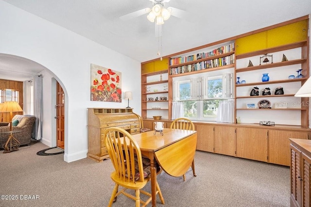 918 N Wild Olive Ave, Daytona Beach, FL 32118 - dining room with arched walkways, a ceiling fan, light colored carpet, and built in features