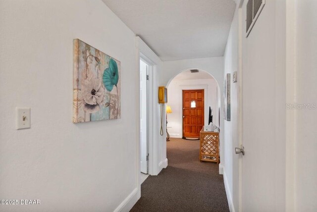 918 N Wild Olive Ave, Daytona Beach, FL 32118 - hallway featuring arched walkways and dark colored carpet