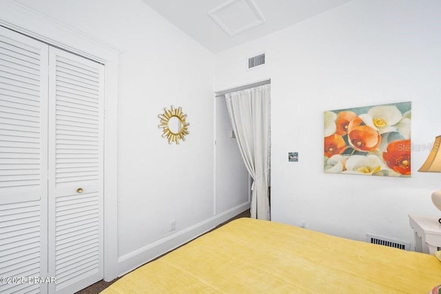 918 N Wild Olive Ave, Daytona Beach, FL 32118 - bedroom featuring attic access, lofted ceiling, and a closet