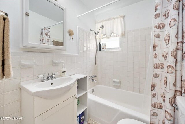 918 N Wild Olive Ave, Daytona Beach, FL 32118 - bathroom featuring vanity, shower / bath combo, and tile walls